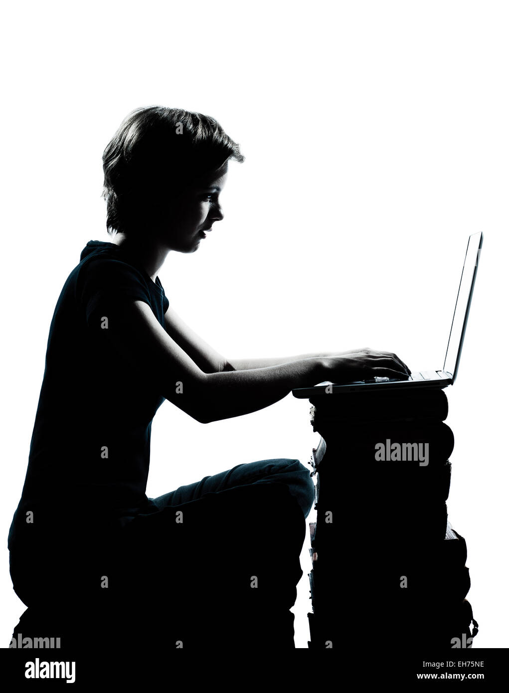 one caucasian young teenager silhouette boy or girl sitting computer computing laptop books full length in studio cut out isolated on white background Stock Photo