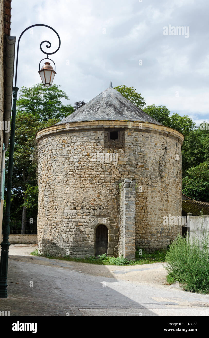 This large stone dovecote in the town of Milly-la-Fôret may date from the early 15th century. Stock Photo