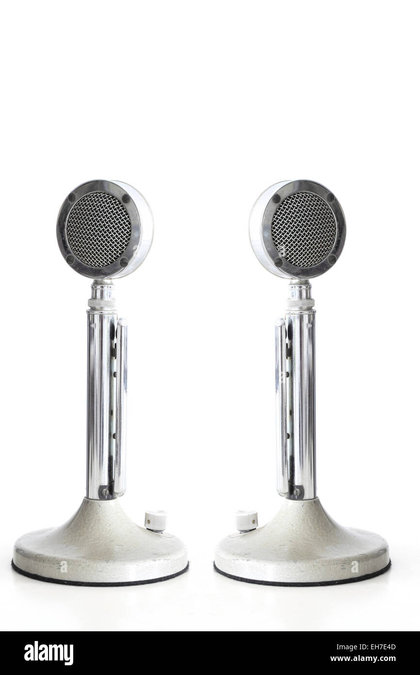 two retro Microphones on white table with its reflection Stock Photo