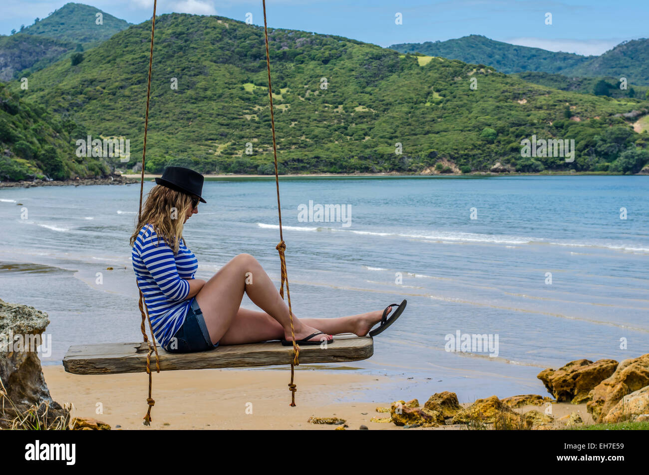 clear, clothes, clothing, company, crossed, crossing, day, distance, expanse, environment, feet, foot, footwear, famous, hat, swing, seascape, peacefu Stock Photo
