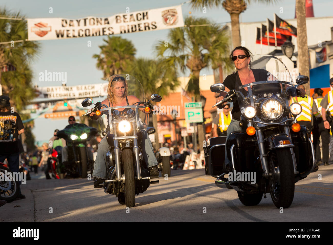 Women bikers ride down Main Street during the 74th Annual Daytona Bike Week March 8, 2015 in Daytona Beach, Florida. More than 500,000 bikers and spectators gather for the week long event, the largest motorcycle rally in America. Stock Photo