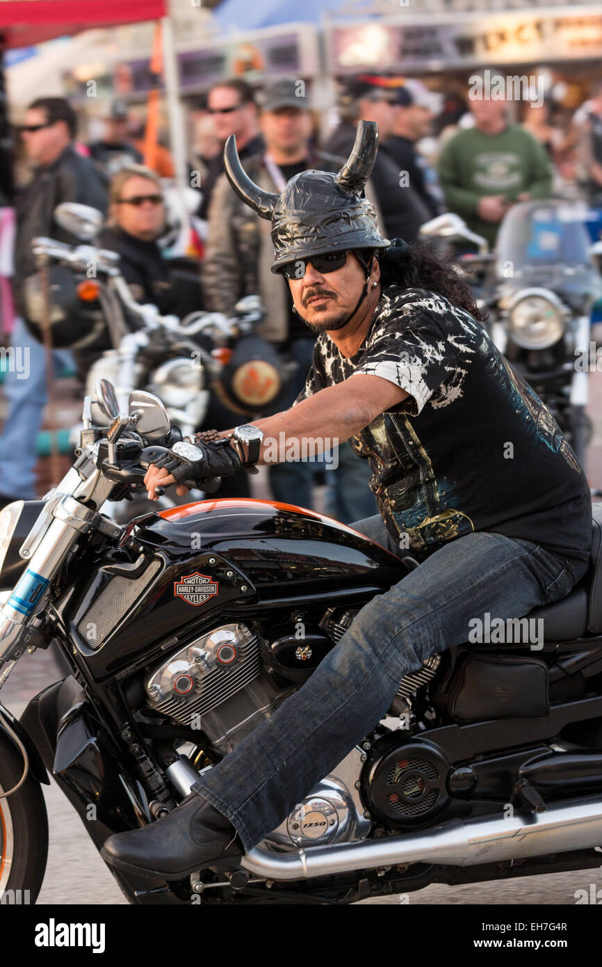 A leather clad biker with animal horns on his helmet cruises down Main Street during the 74th Annual Daytona Bike Week March 8 2015 in Daytona Beach Florida. More than 500 000 bikers