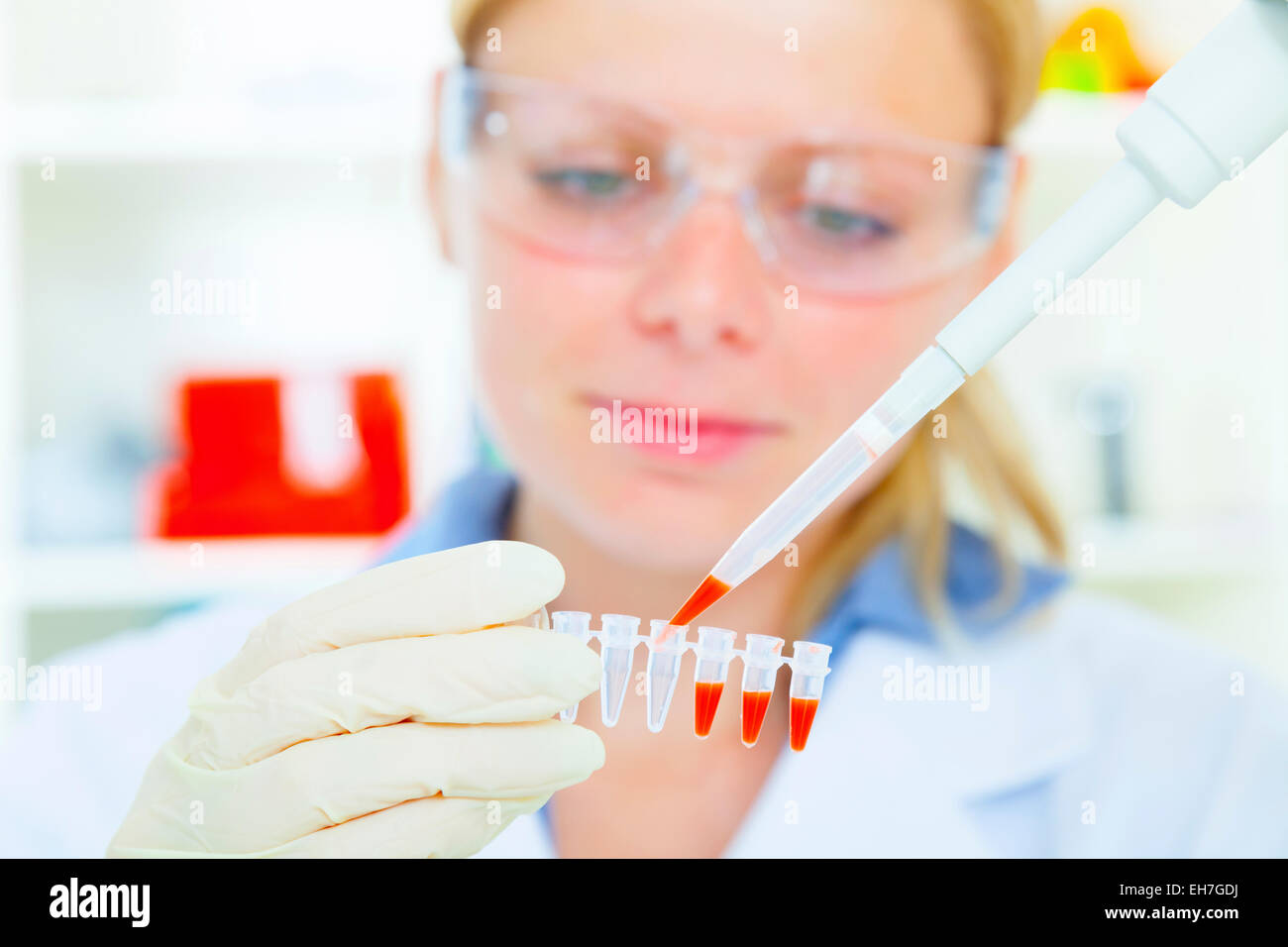 Tech Using Pipette Female technician using a pipette Stock Photo - Alamy