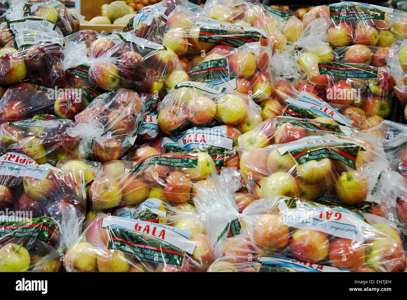 Bags of Gala apples in a supermarket display in the fruit and vegetable