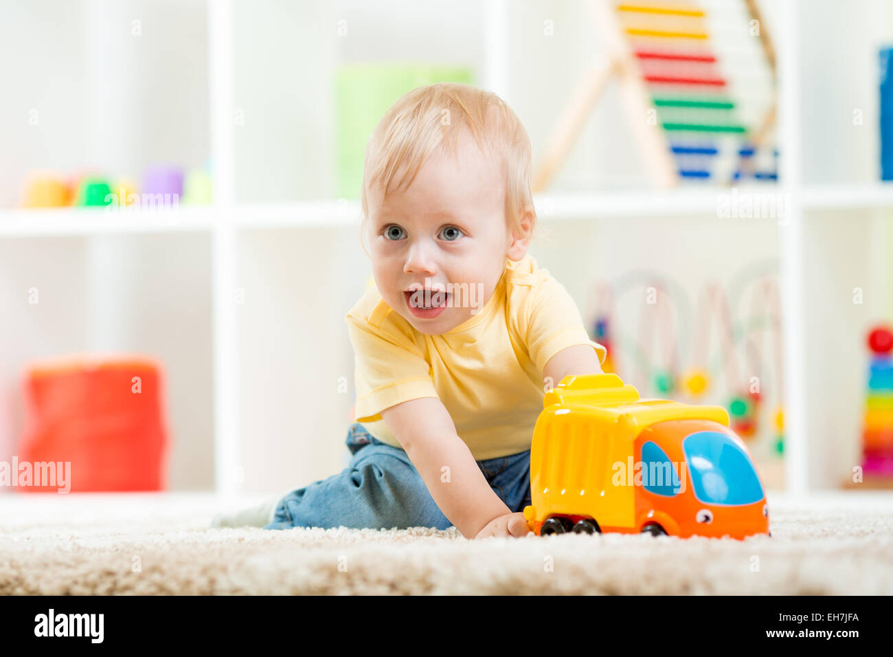 child boy toddler playing with toy car Stock Photo