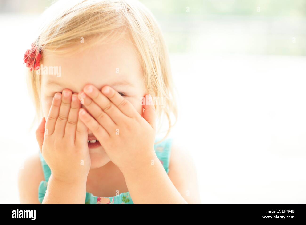 Young girl covering face with hands Stock Photo - Alamy