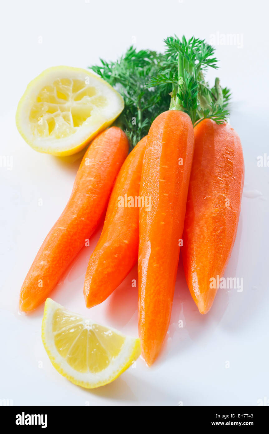Peeled fresh carrots with tops. Stock Photo