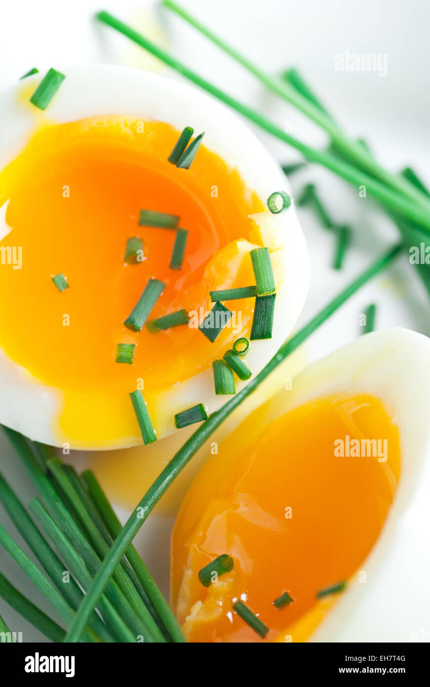 Soft boiled egg halves with chive. Stock Photo