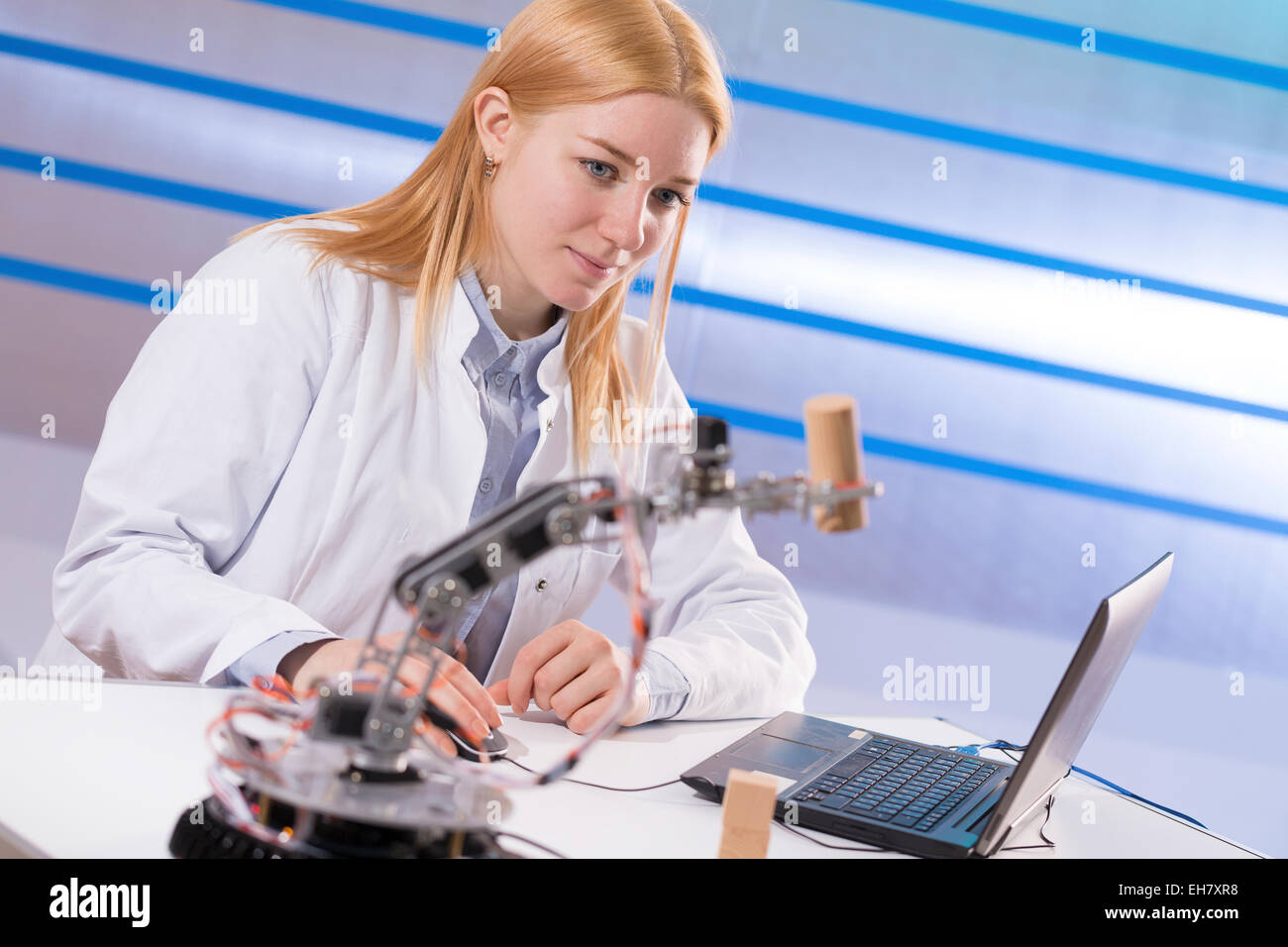 Female student working in a robotics lab Stock Photo