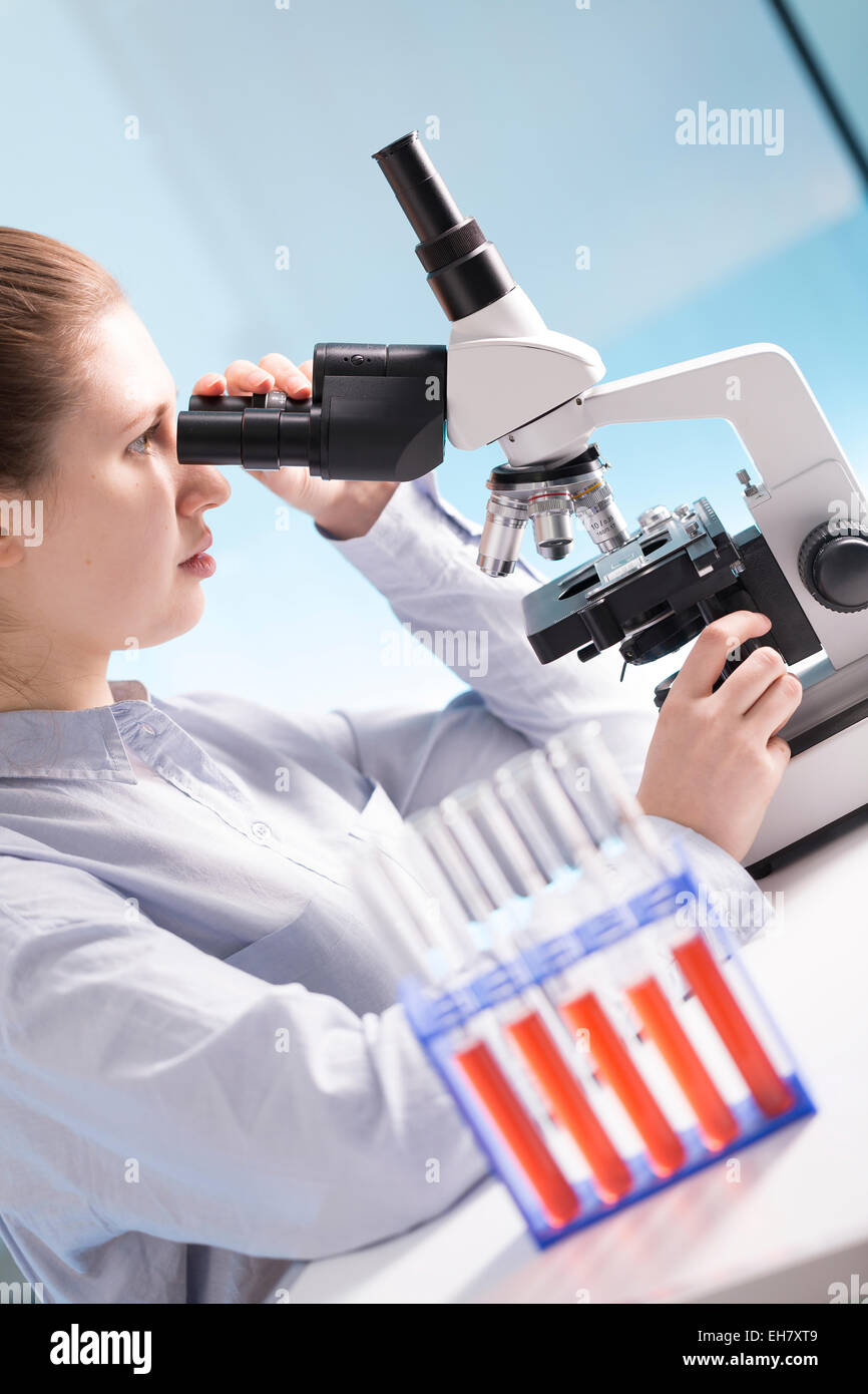 Student using microscope in lab Stock Photo - Alamy