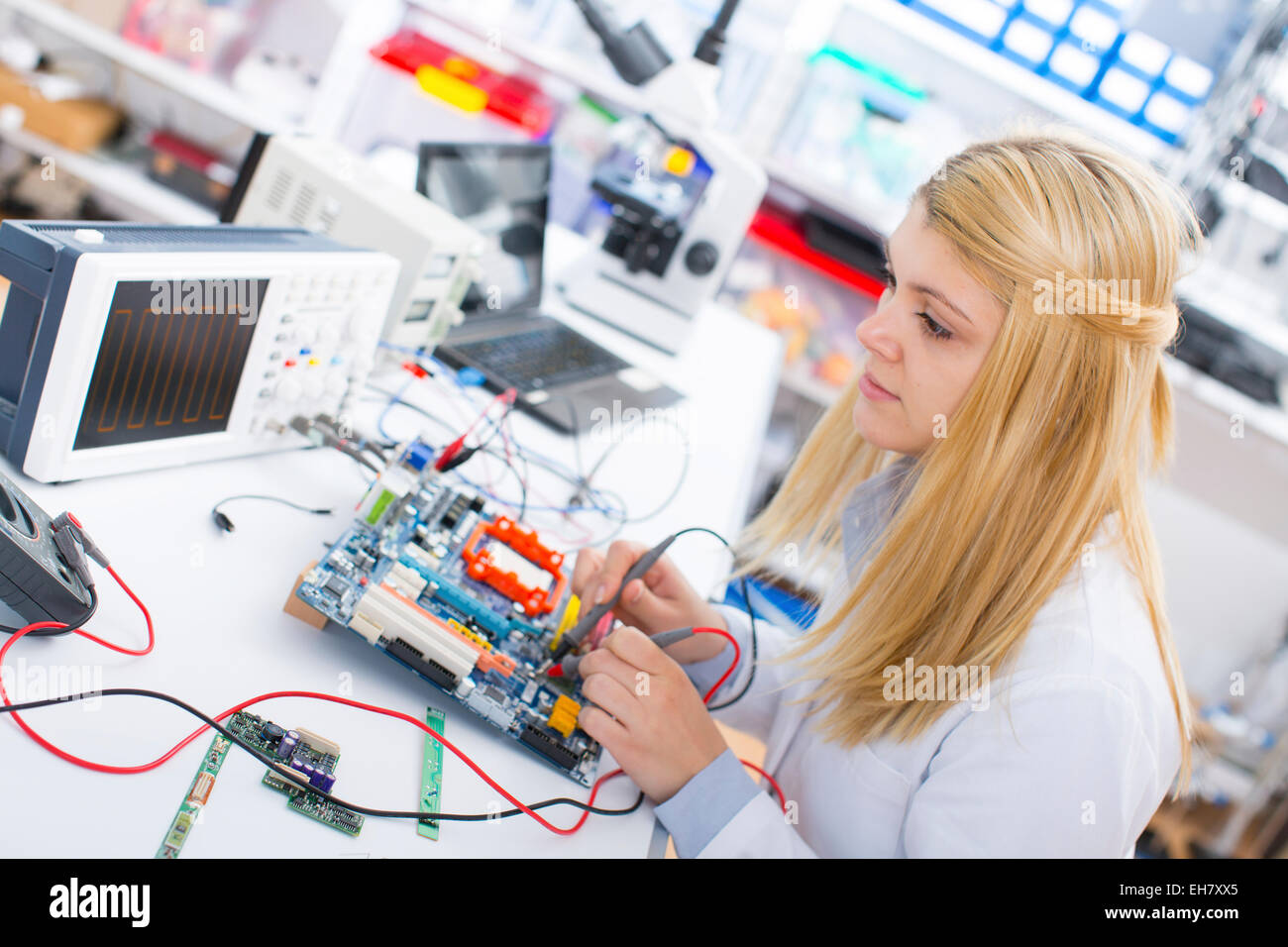 Lab assistant using a circuit board Stock Photo - Alamy