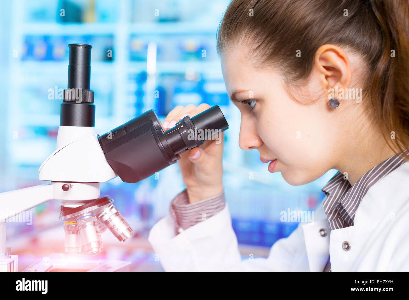 Lab assistant using microscope Stock Photo - Alamy