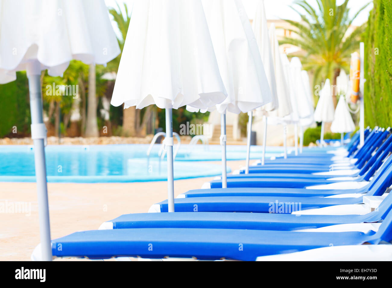 Sunloungers and parasols in a row Stock Photo