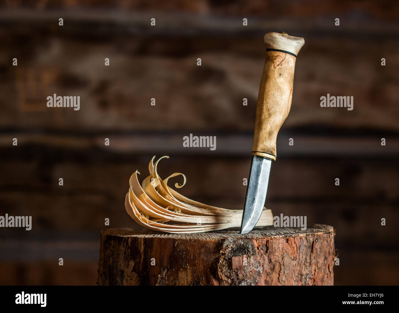 A traditional Finnish knife (puukko) and a feather stick. Stock Photo