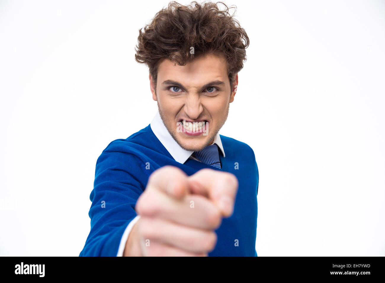 Angry young man pointing at you over white background Stock Photo - Alamy