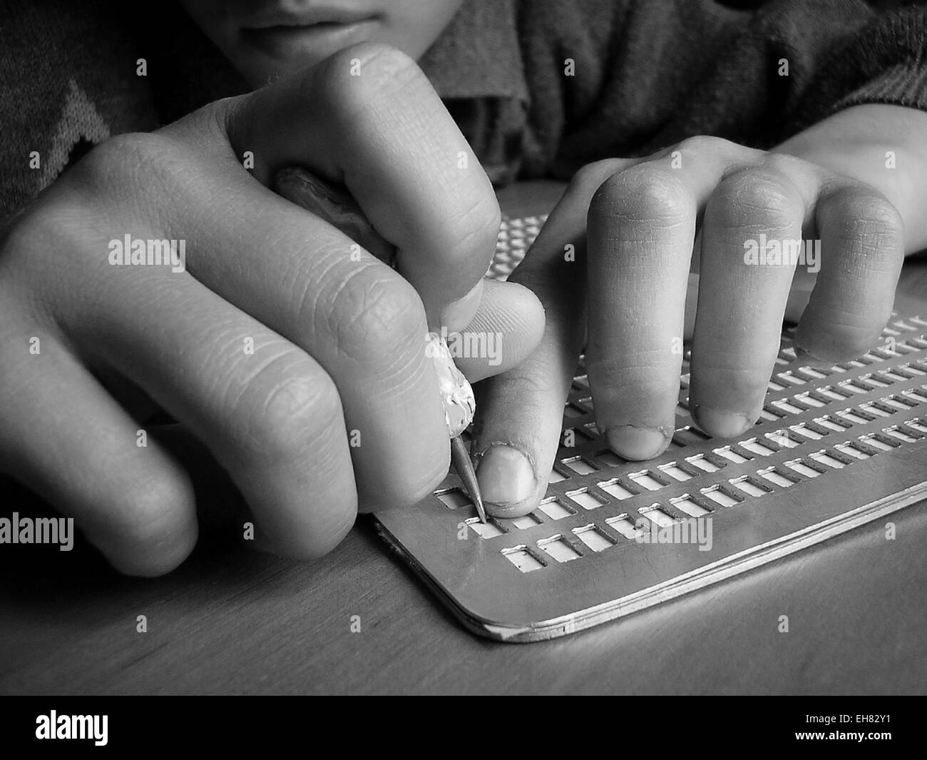 Close up of children's hand writing in Braille Stock Photo