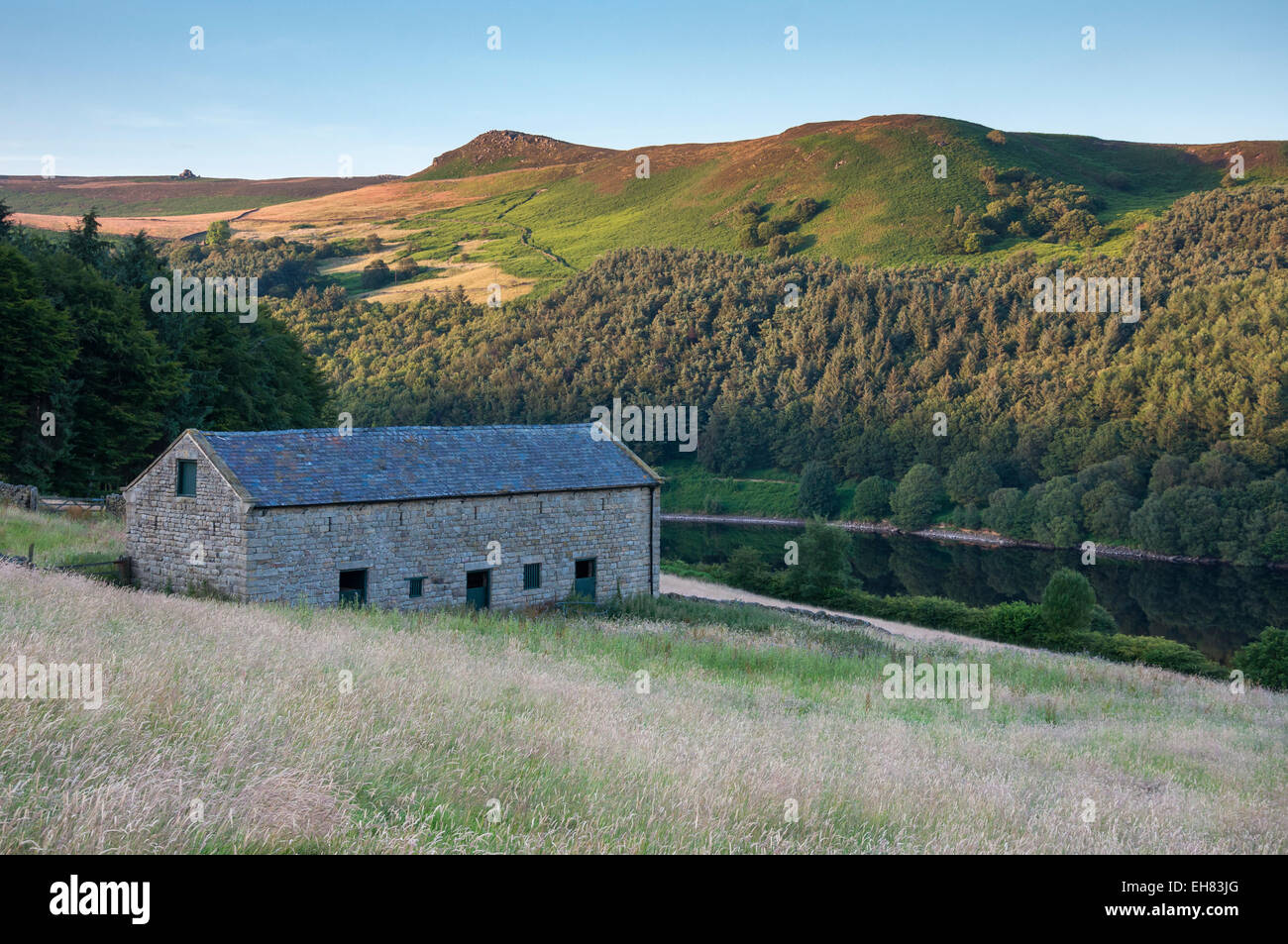 Stone barn beside Ladybower reservoir in the Peak District, Derbyshire on a pleasant summer evening. Stock Photo