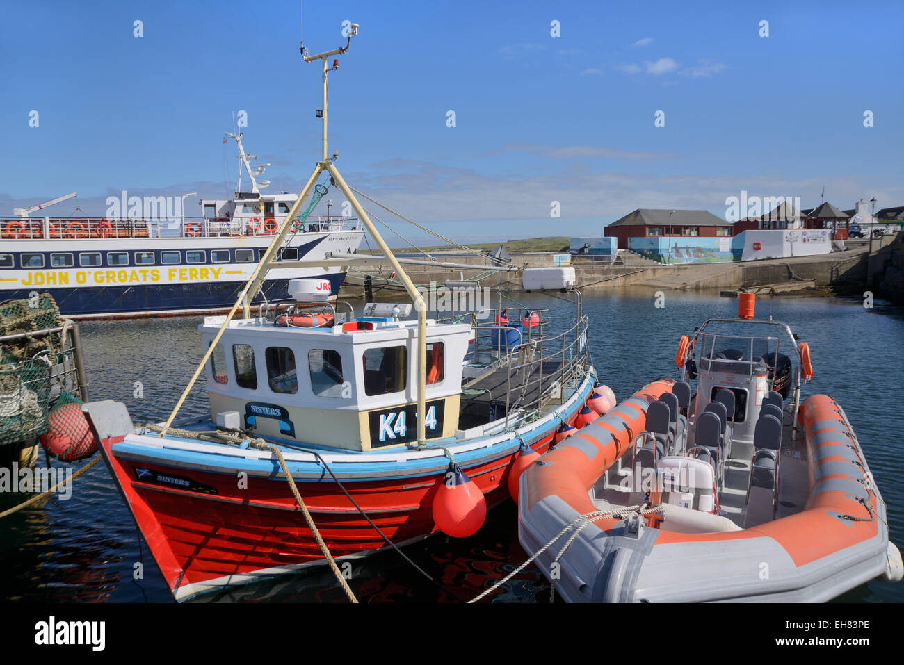 Fishing boat and rigid-inflatable boat in the harbour, John O'Groats, Caithness, Highland Region, Scotland, United Kingdom Stock Photo