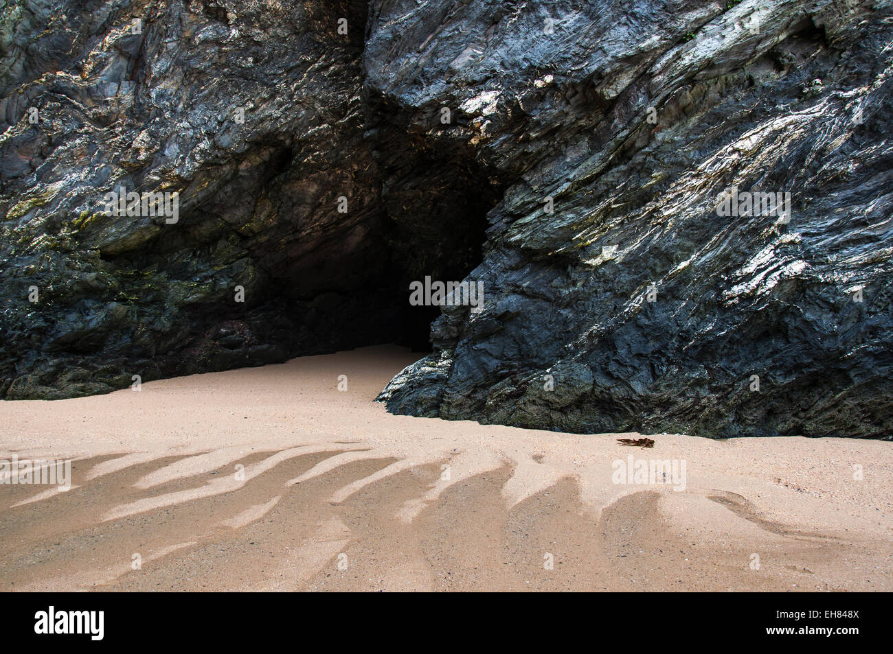 Mysterious cave in the cliffs at Crantock beach near Newquay in Cornwall, England. Stock Photo