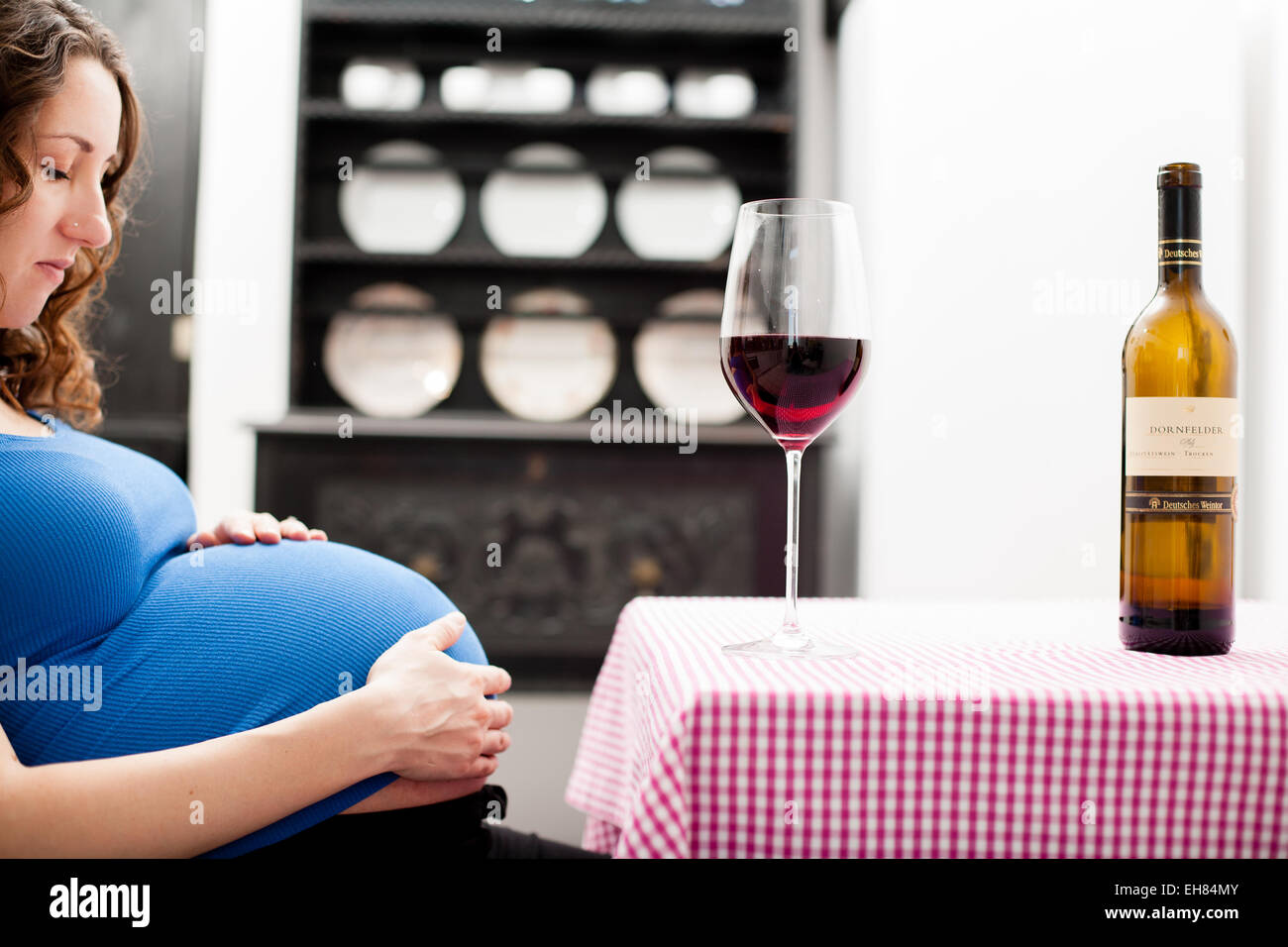 Woman in full term pregnancy drinking red wine Stock Photo Alamy