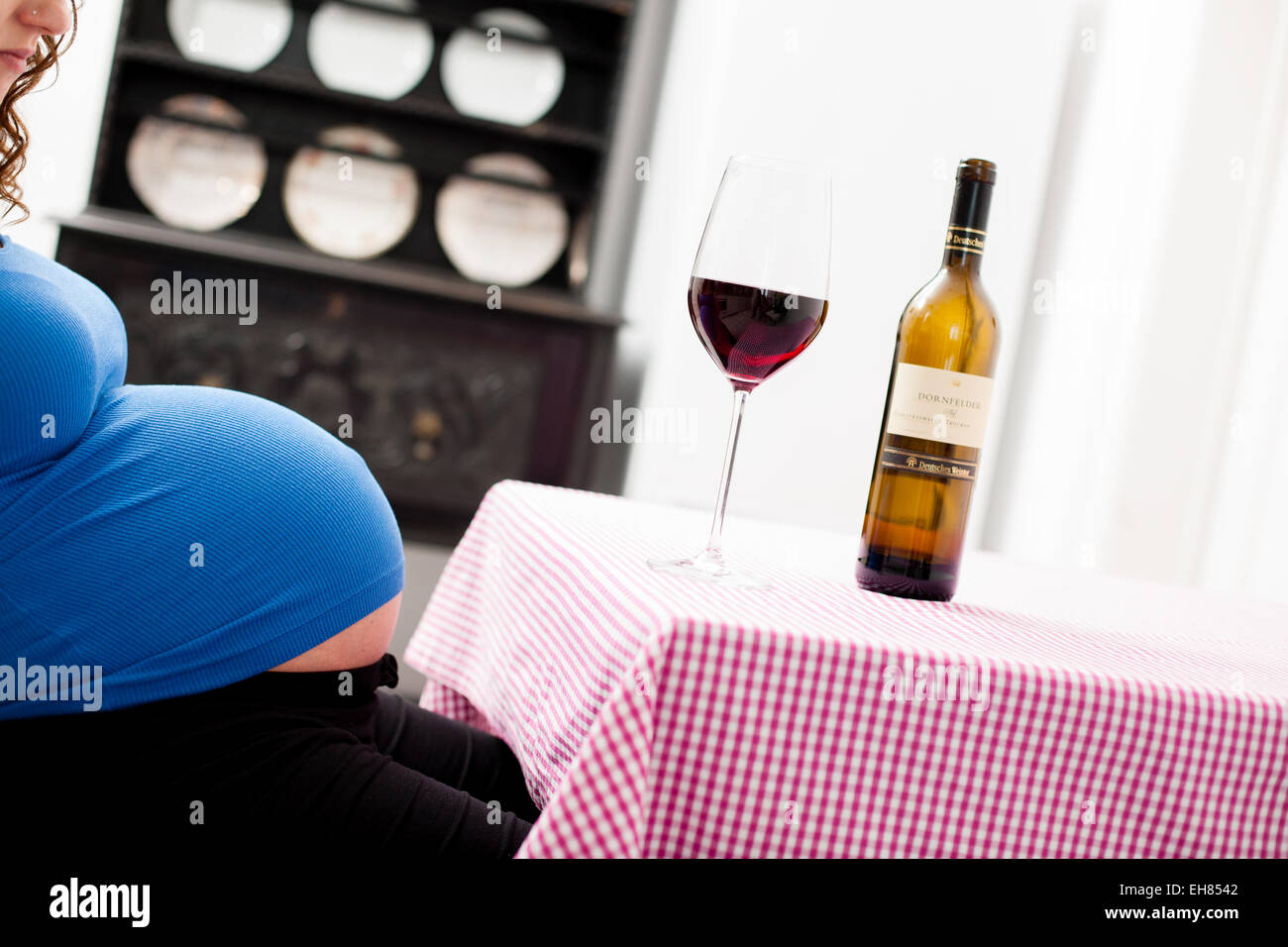 Woman in full term pregnancy drinking red wine Stock Photo Alamy