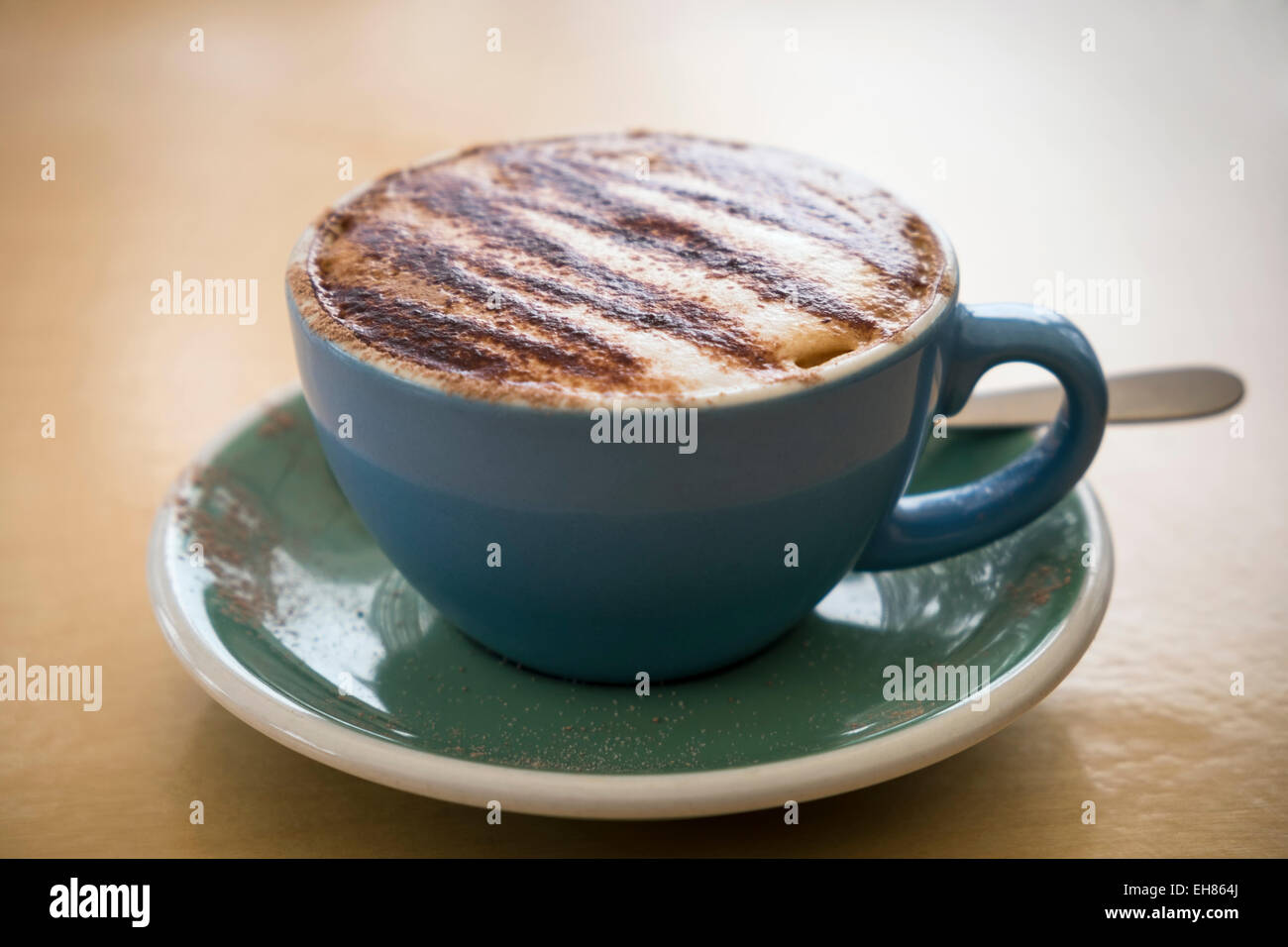 Cup of cappuccino coffee with chocolate sprinkled on top. Stock Photo