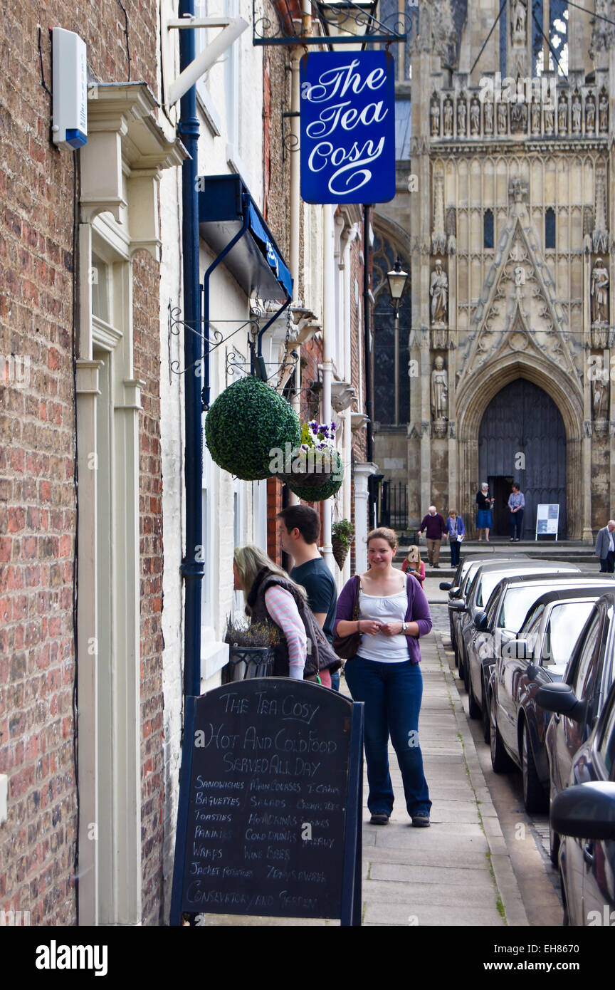 Three people entering 'The Tea Cosy' tea shop, near the Minster, Highgate Beverley, East Riding of Yorkshire, England Stock Photo