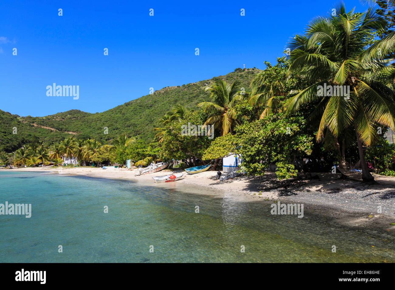 Clear water, beach, boats and palms, Great Harbour, Jost Van Dyke, British Virgin Islands, West Indies, Caribbean Stock Photo