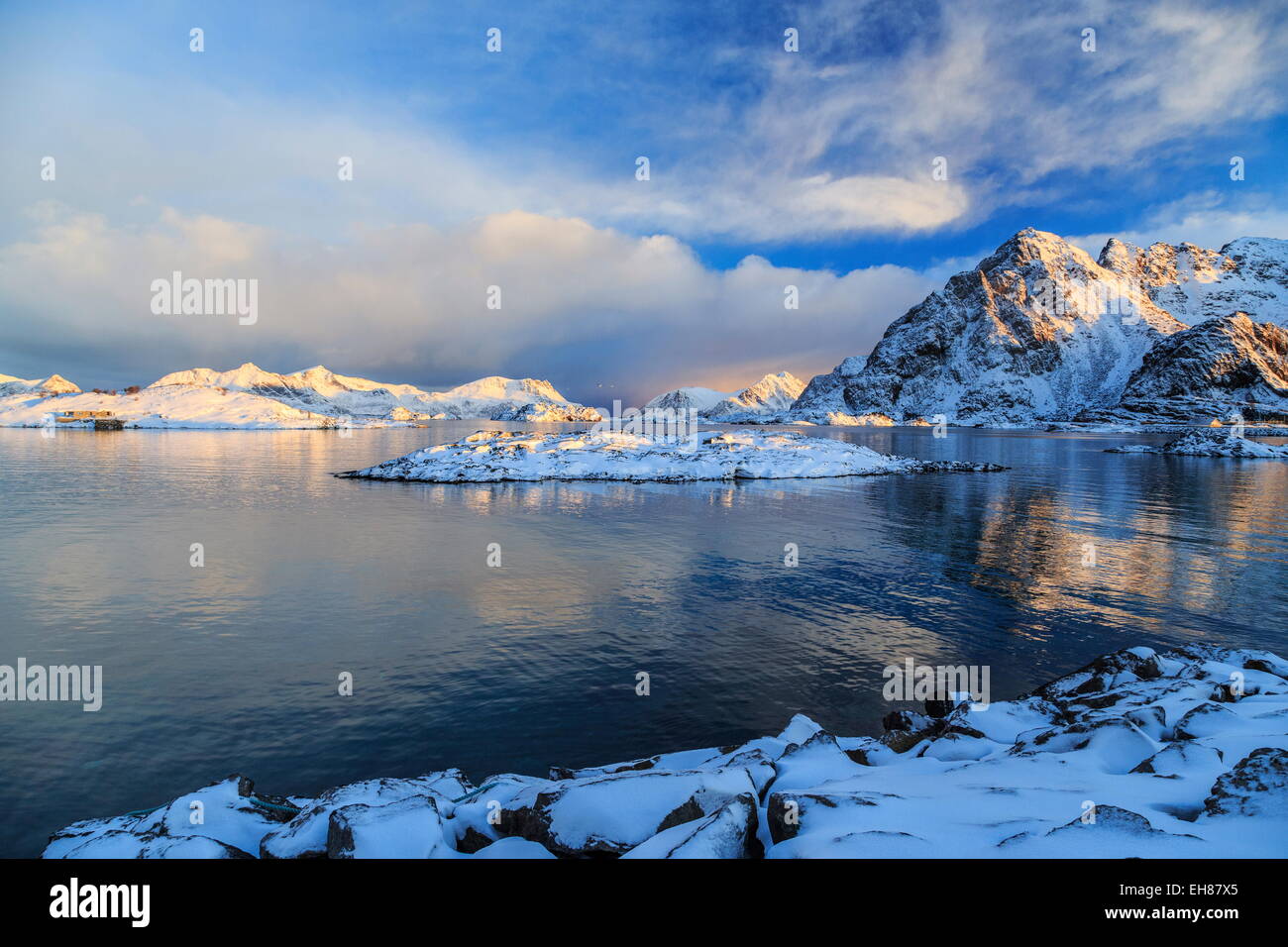 The feeble light of the sunset on a fjord near Henningsvaer covered in snow, Lofoten Islands, Arctic, Norway Stock Photo