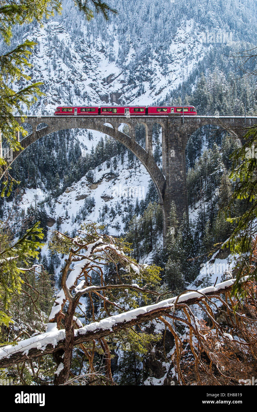 The Bernina Express crossing the Wiesen Viaduct in the Swiss Canton of Graubunden, Switzerland, Europe Stock Photo