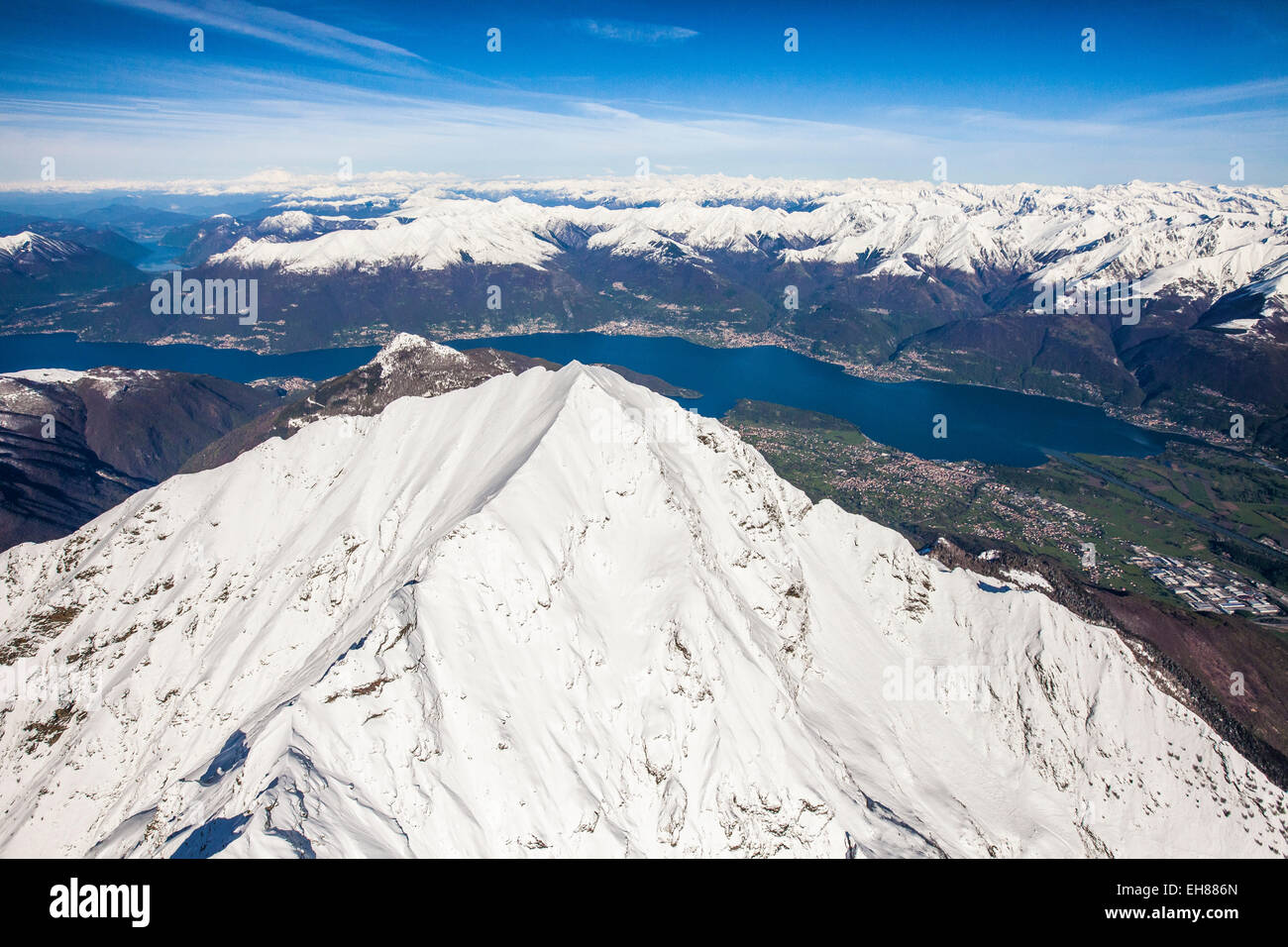 The peak of Mount Legnone coveres in snow and Lake Como and the Monti Lariani in the background, Lombardy, Italy, Europe Stock Photo