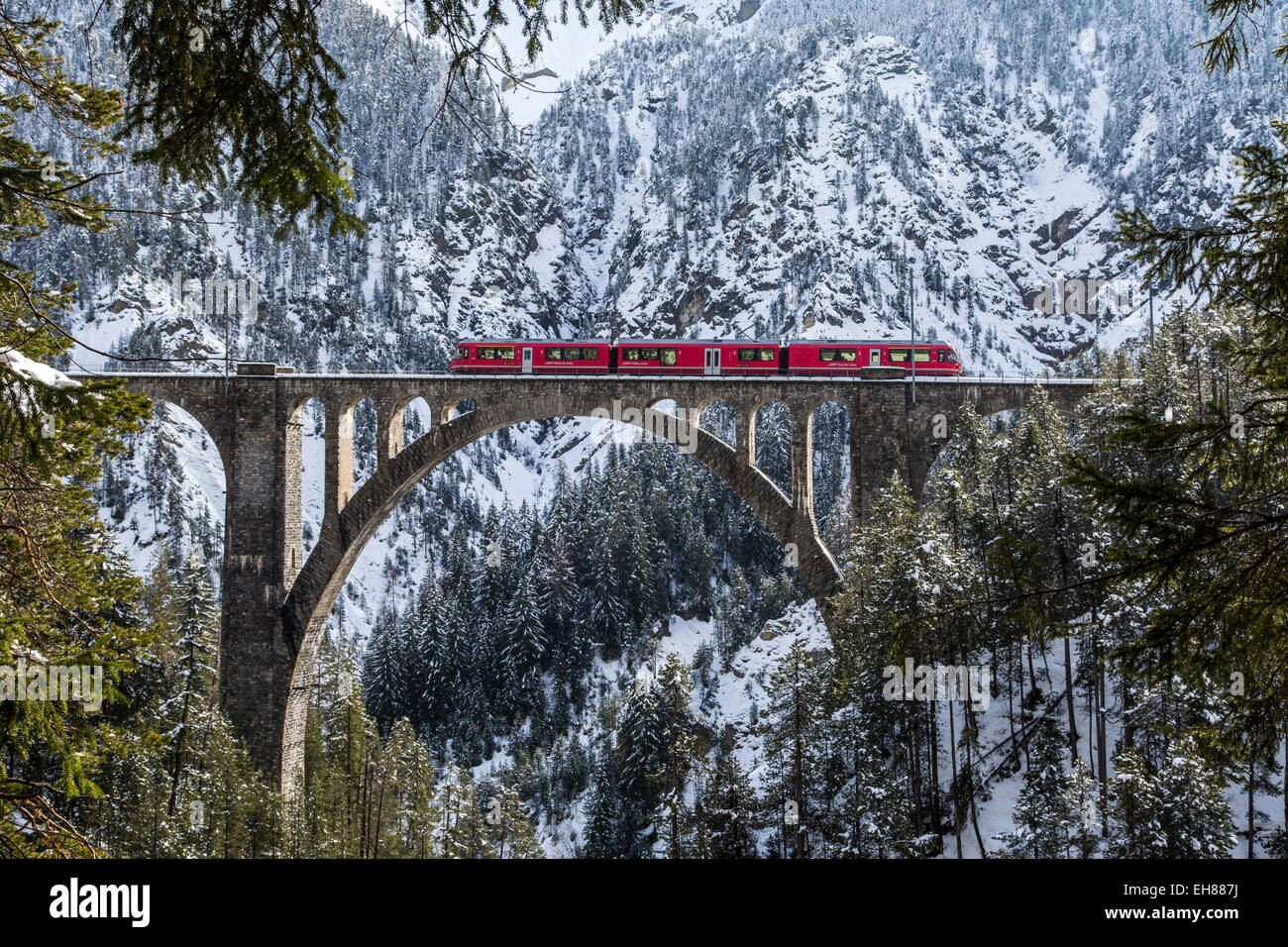 The Bernina Express crossing the Wiesen Viaduct in the Canton of Graubunden, Switzerland, Europe Stock Photo