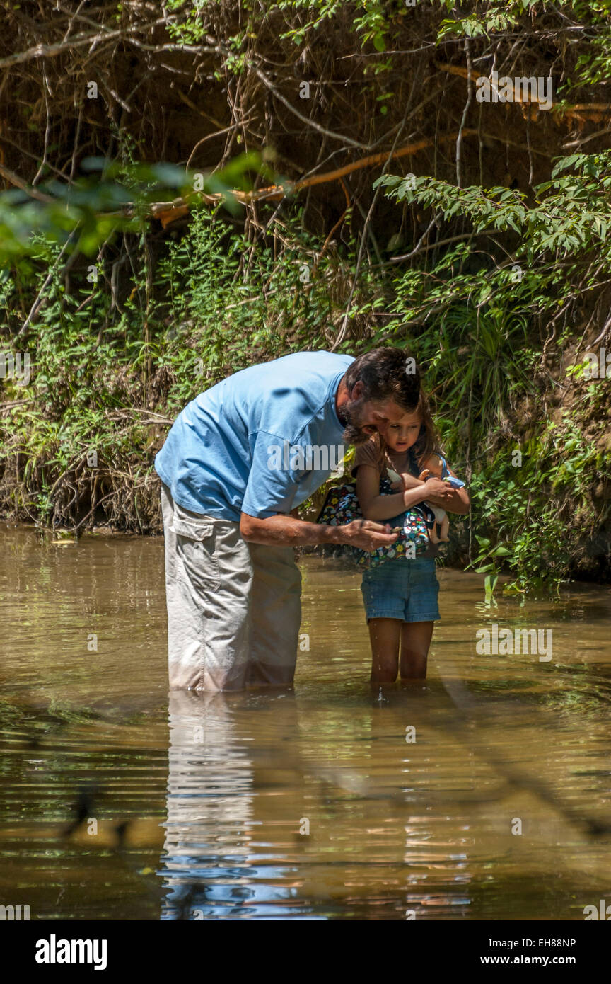 Father and daughter exploring nature on a small stream in Tennessee USA Stock Photo