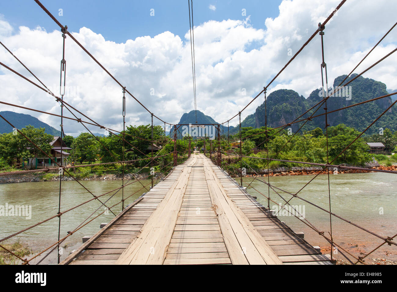 Wooden bridge over Nam Song river, Vang Vieng village, Laos Stock Photo