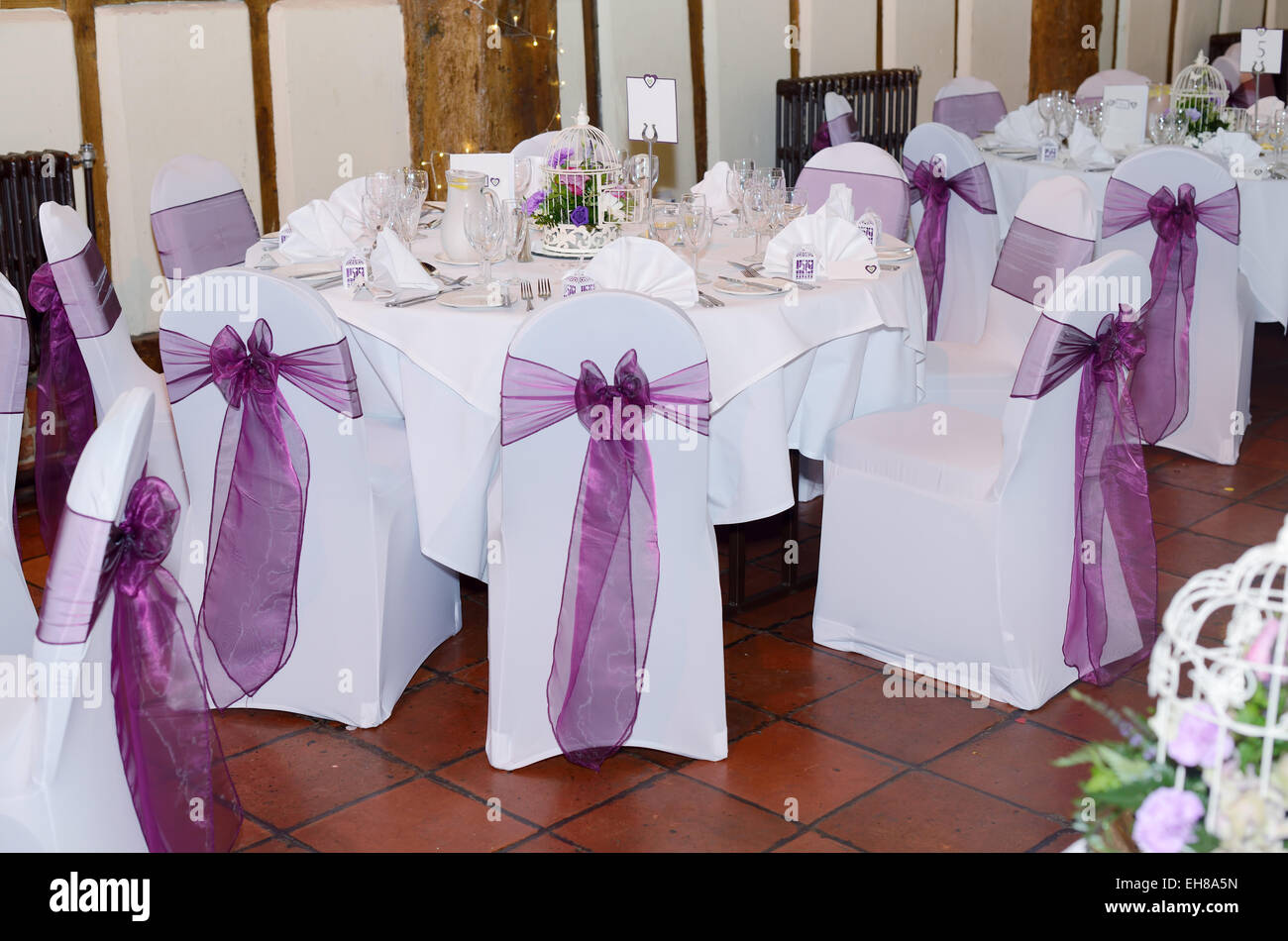Wedding reception showing chair and table covers in white and purple Stock Photo
