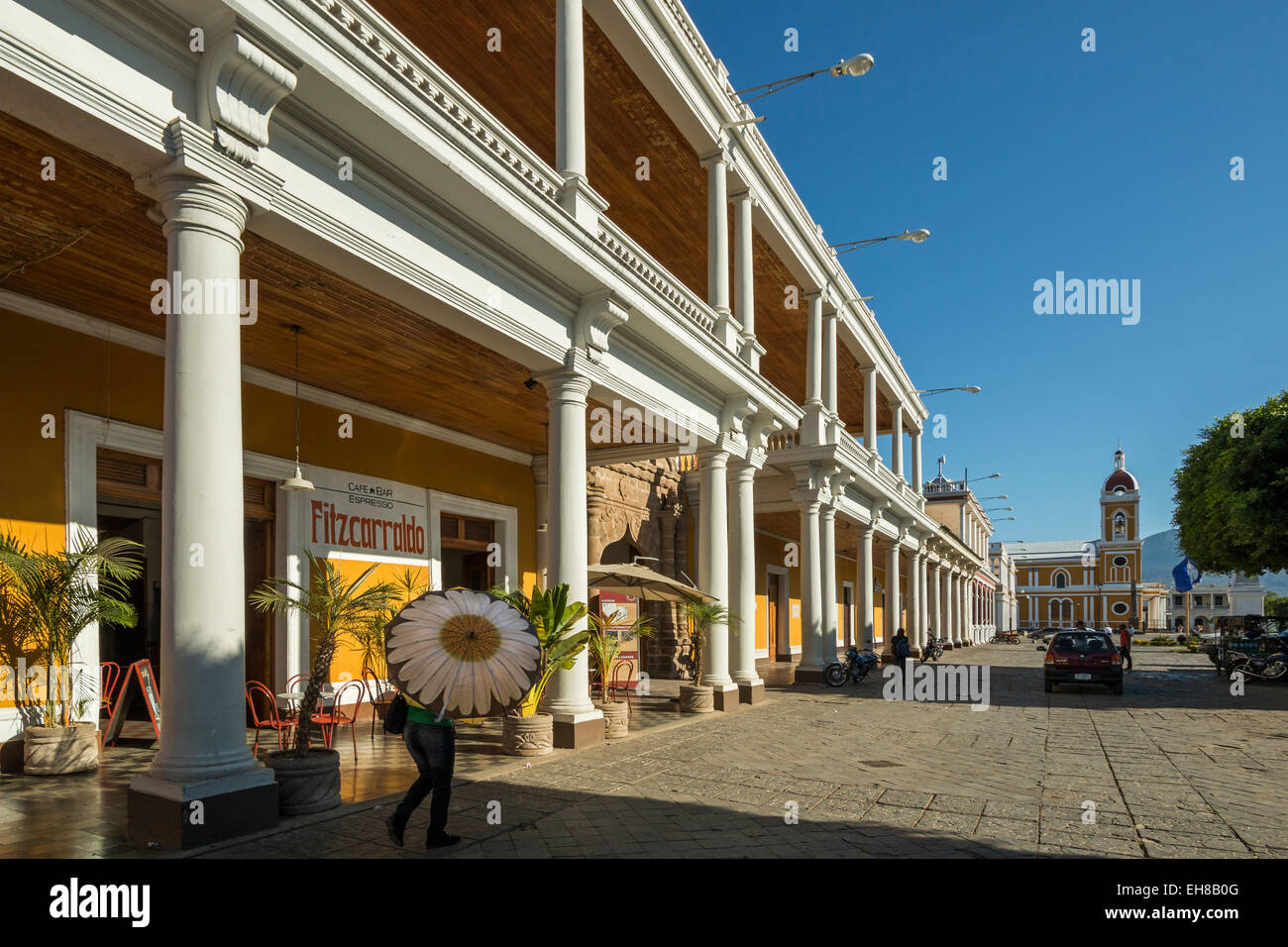 View along colonnades of Plaza de la Independencia to Granada Cathedral in the heart of this historic city, Granada, Nicaragua Stock Photo
