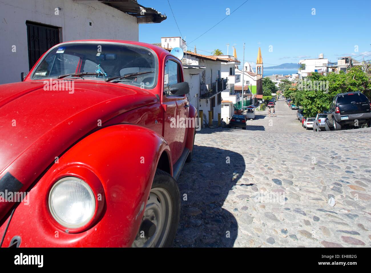 Red Volkswagen Beetle in residential street, Downtown, Puerto Vallarta, Jalisco, Mexico, North America Stock Photo