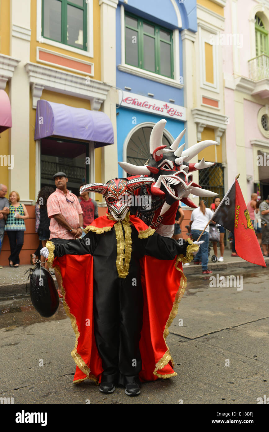 An adult and a young vejigante posing during the carnival in Ponce, Puerto Rico. February 2015. Stock Photo