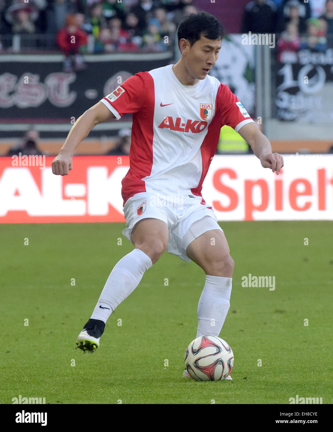 Augsburg, Germany. 07th Mar, 2015. Augsburg's Ji Dong Won plays the ball duirng the German Bundesliga soccer match between FC Augsburg and VfL Wolfsburg at SGL-Arena in Augsburg, Germany, 07 March 2015. Photo: Stefan Puchner/dpa/Alamy Live News Stock Photo