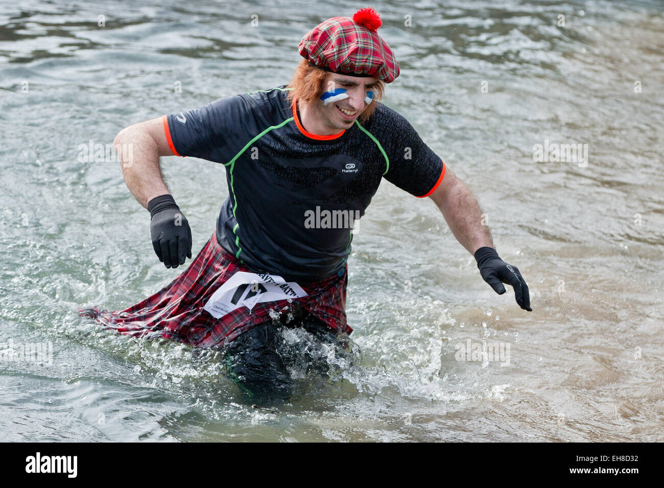 A Participant struggles through a muddy river  during the extreme course event 'Braveheart-Battle' in Muennerstadt, Germany, 7 Mrach 2015. Around 2,500 runners have to over come 28 kilometres with 50 challanging obstacles wchih includes freezing cold water, mud pits and burning fire obstacles. The Braveheart-Battle course is considered one of the toughest in Europe. Photo:  Daniel Karmann/dpa Stock Photo