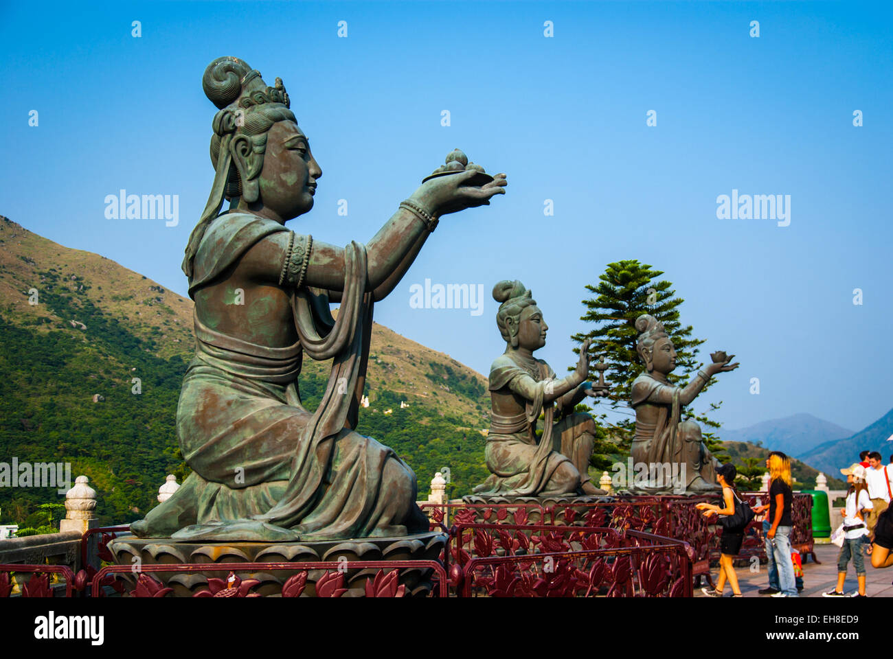 Goddesses holding out offerings to the giant Tian Tan Buddha on Lantau Island, Hong Kong Stock Photo