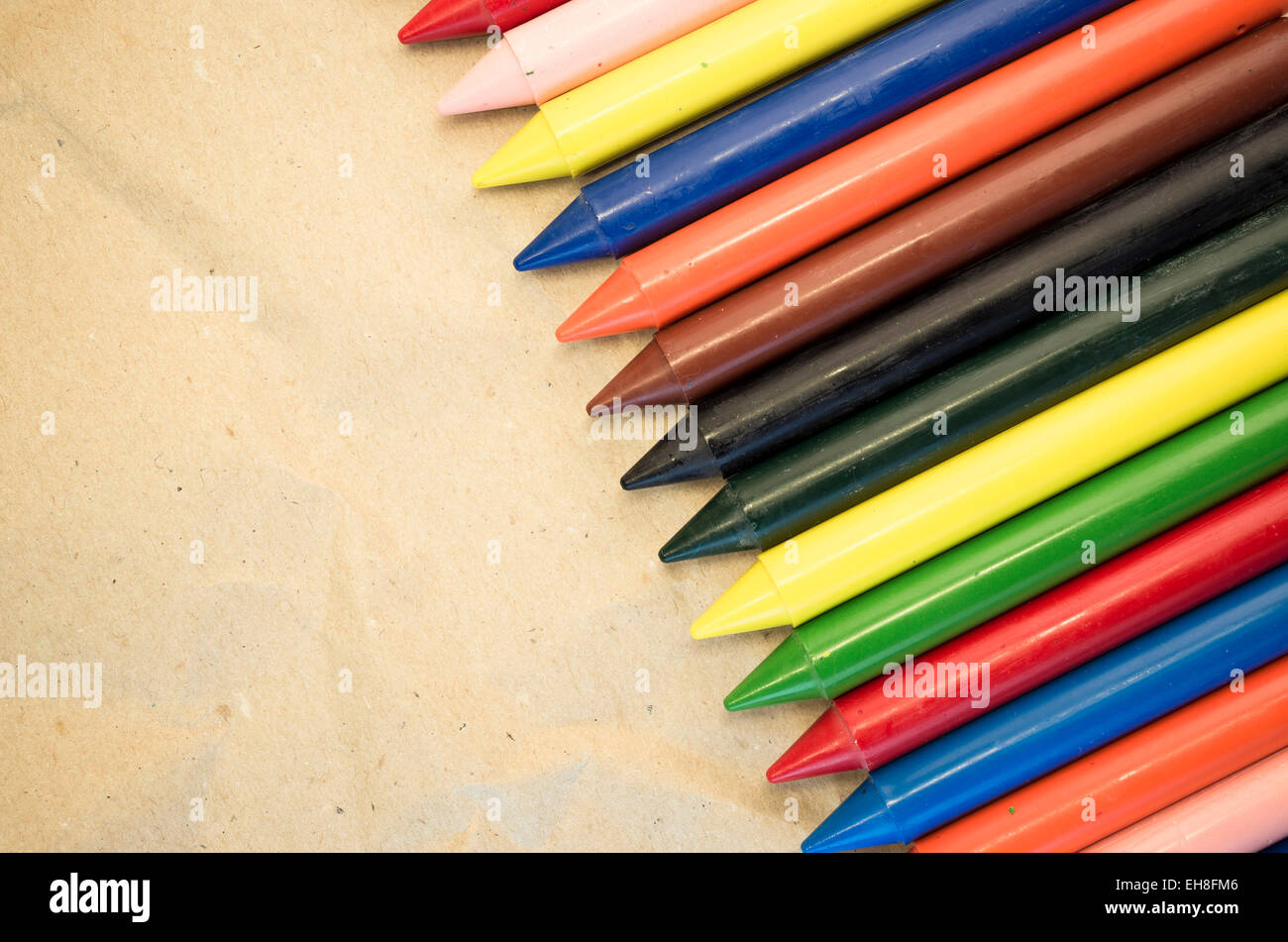 set of lined up colored wax crayons close up - recycled paper ...