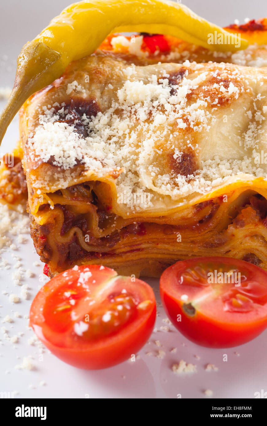 Lasagna with grated cheese and tomato. Stock Photo