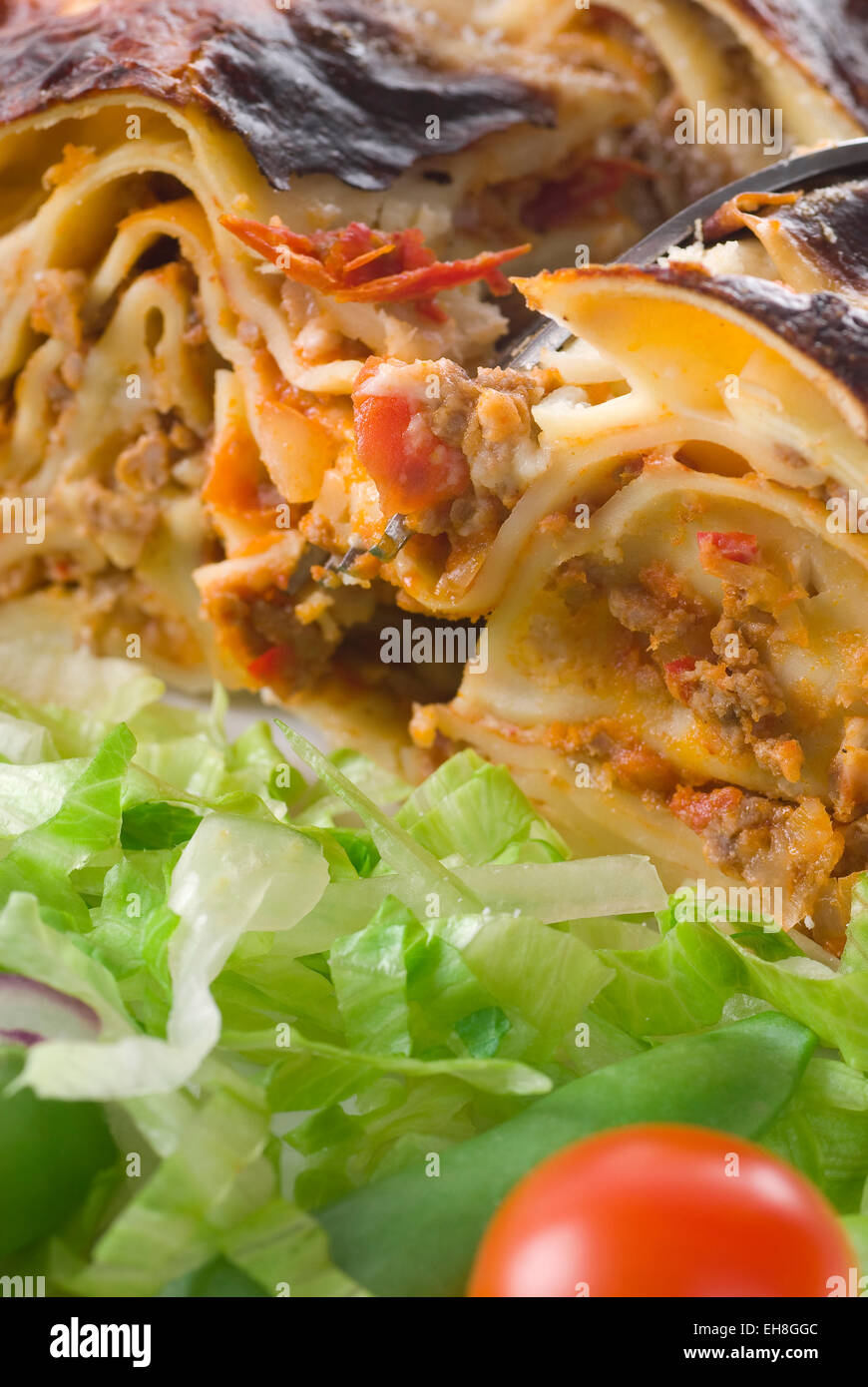 Piece of lasagna with a fork. Stock Photo