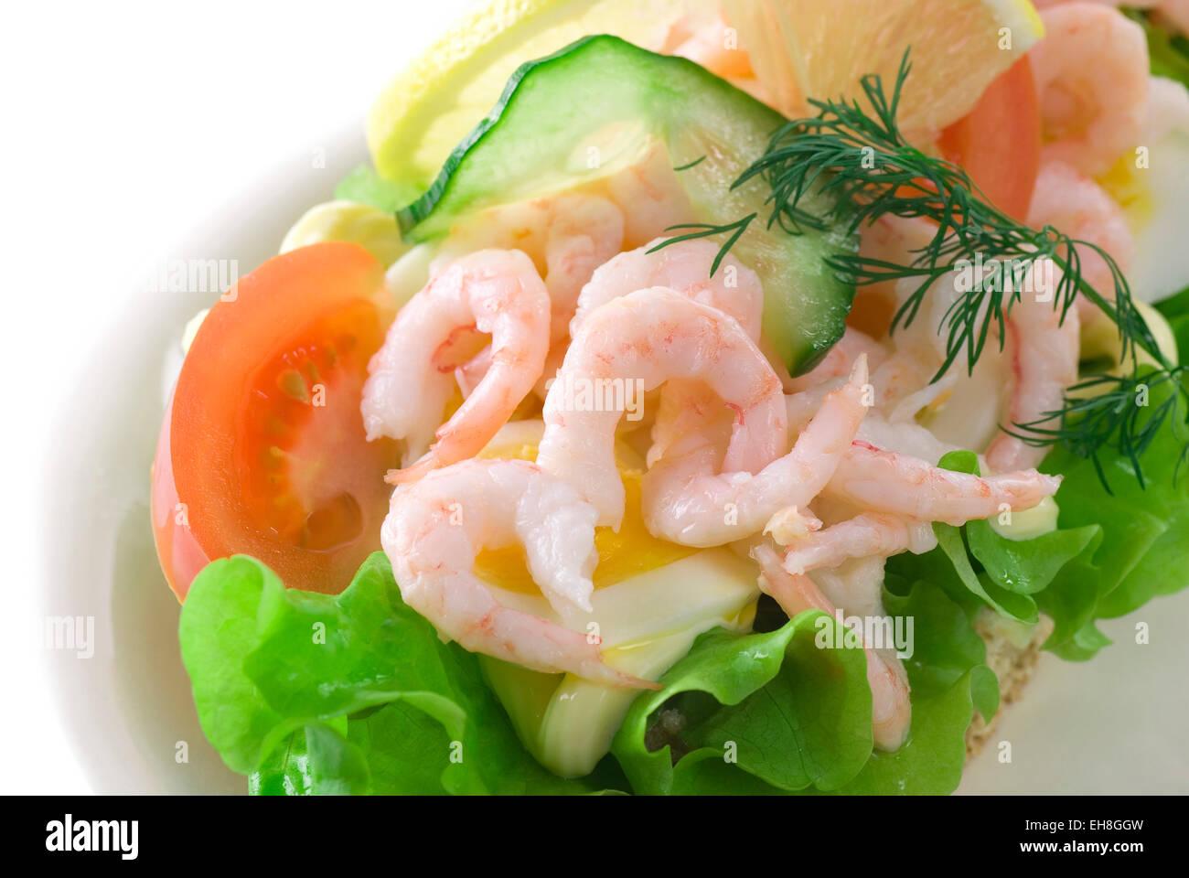 Shrimp sandwich with mayonnaise, lettuce, tomato, cucumber, lemon, dill and egg. Stock Photo