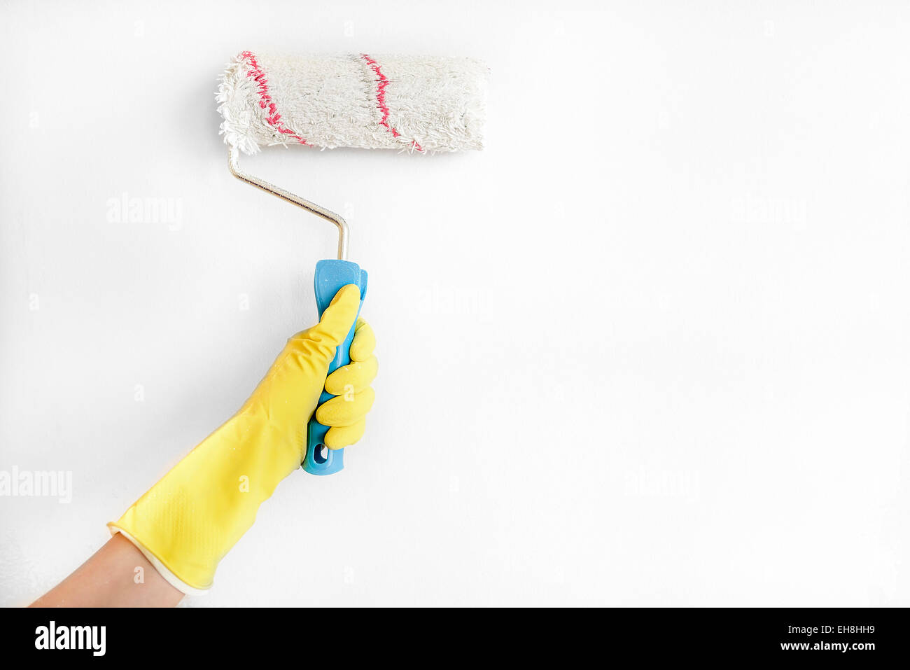 Woman painting wall with roller brush Stock Photo Alamy