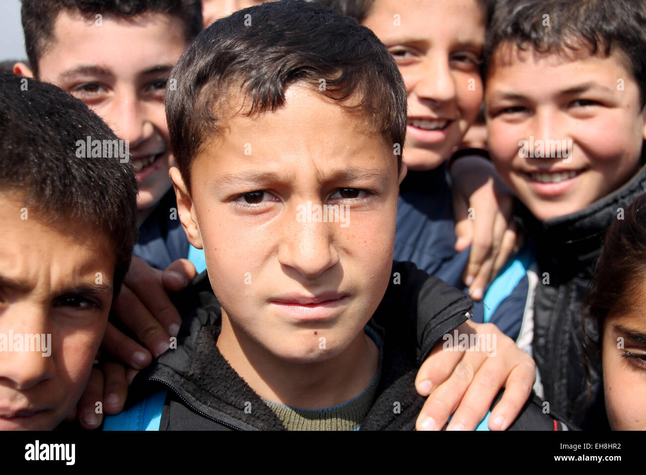 Kahramanmaras, Turkey. 3rd Mar, 2015. Mohammad (C) from Syria stands surrounded by his friends in the refugee camp in Kahramanmaras, Turkey, 3 March 2015. More than 3.8 million Syrians have escaped the civil war in Syria since the beginning of the war four years ago on Sunday 15th March. Mohammad, who would like to become a physician, is one of 1, 6 million refugees who have found refuge in Turkey. No other country has been harbouring more refugees. The situation of Syrian refugees, however, remains hopeless despite the Turkey's strong efforts. Photo: Can Merey/dpa/Alamy Live News Stock Photo
