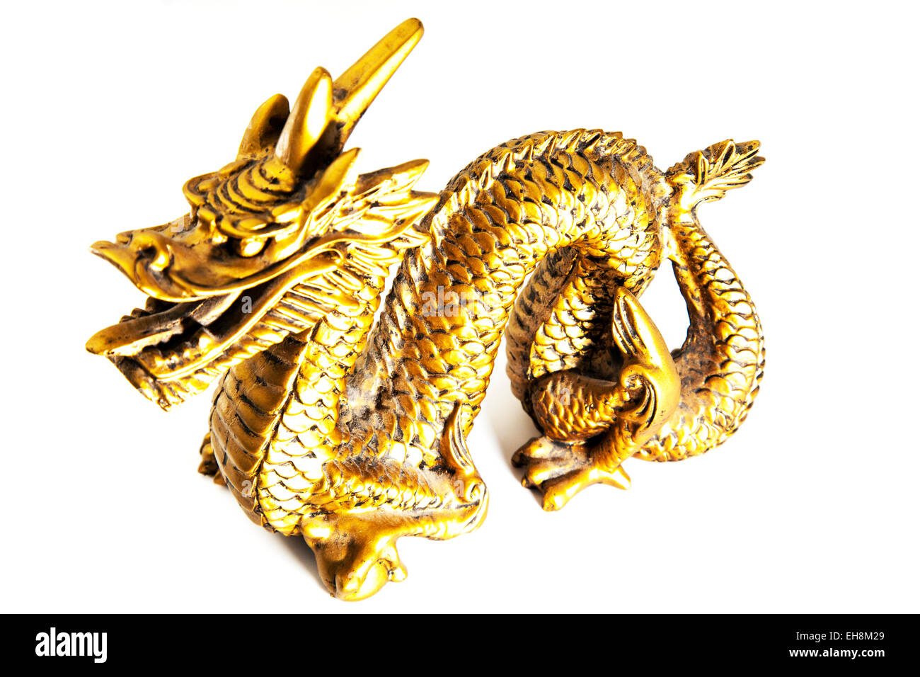 Chinese gold dragon ornament ornamental head body side on cutout white background copy space isolated Stock Photo