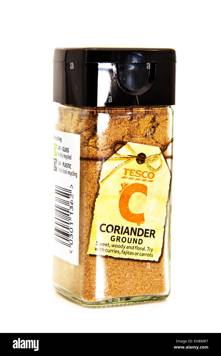 Coriander ground powder food flavouring flavour flavor in jar tesco logo product cutout white background copy space isolated Stock Photo