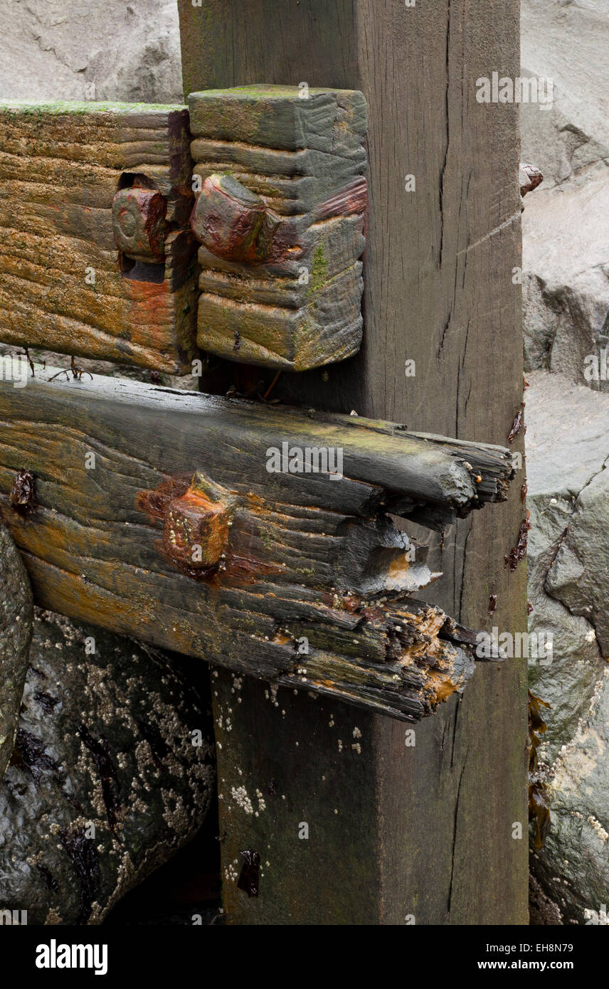 Sea defenses of wood metal bolts and rock Stock Photo